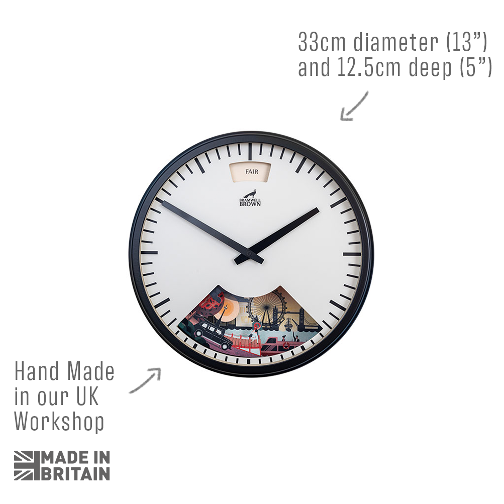 Round wall clock with black frame, minimal white face, and a small, colorful illustration of a fairground at the bottom. Text highlights its UK handmade origin and dimensions: 33cm diameter and 12.5cm deep.
