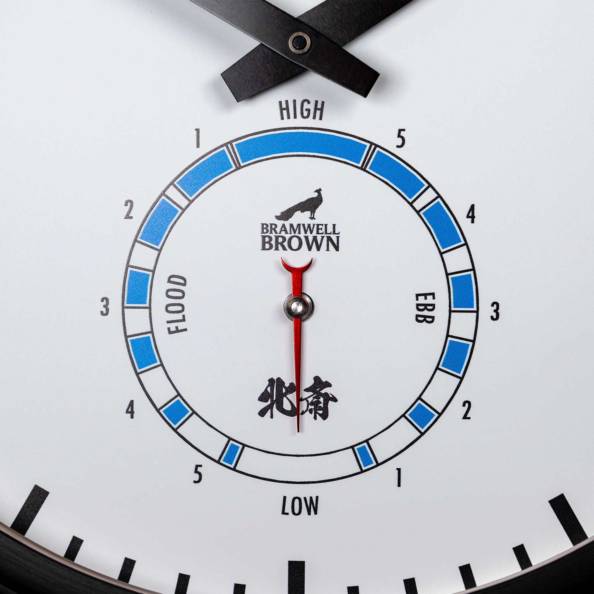 The Hokusai Tide Art Clock, inspired by the Great Wave Off Kanagawa, displays HIGH and LOW tides with blue and white segments. Bramwell Brown branding and a graphic appear at the top center of the clock face.