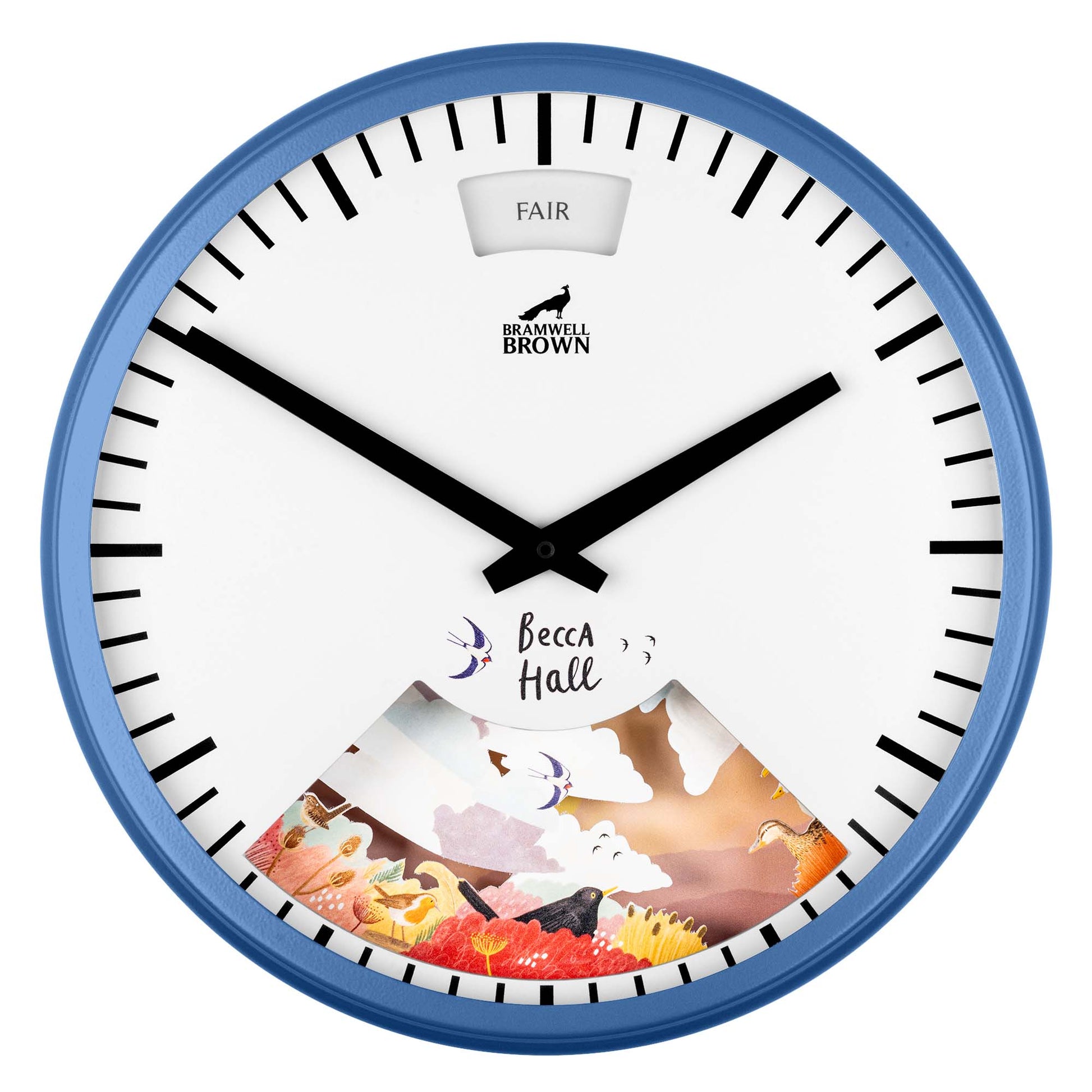 A round wall clock with a blue frame features bold black hands and hour marks. The lower part displays colorful artwork of nature elements, and a window at the top reads “FAIR.” The brand name Bramwell Brown is at the center.