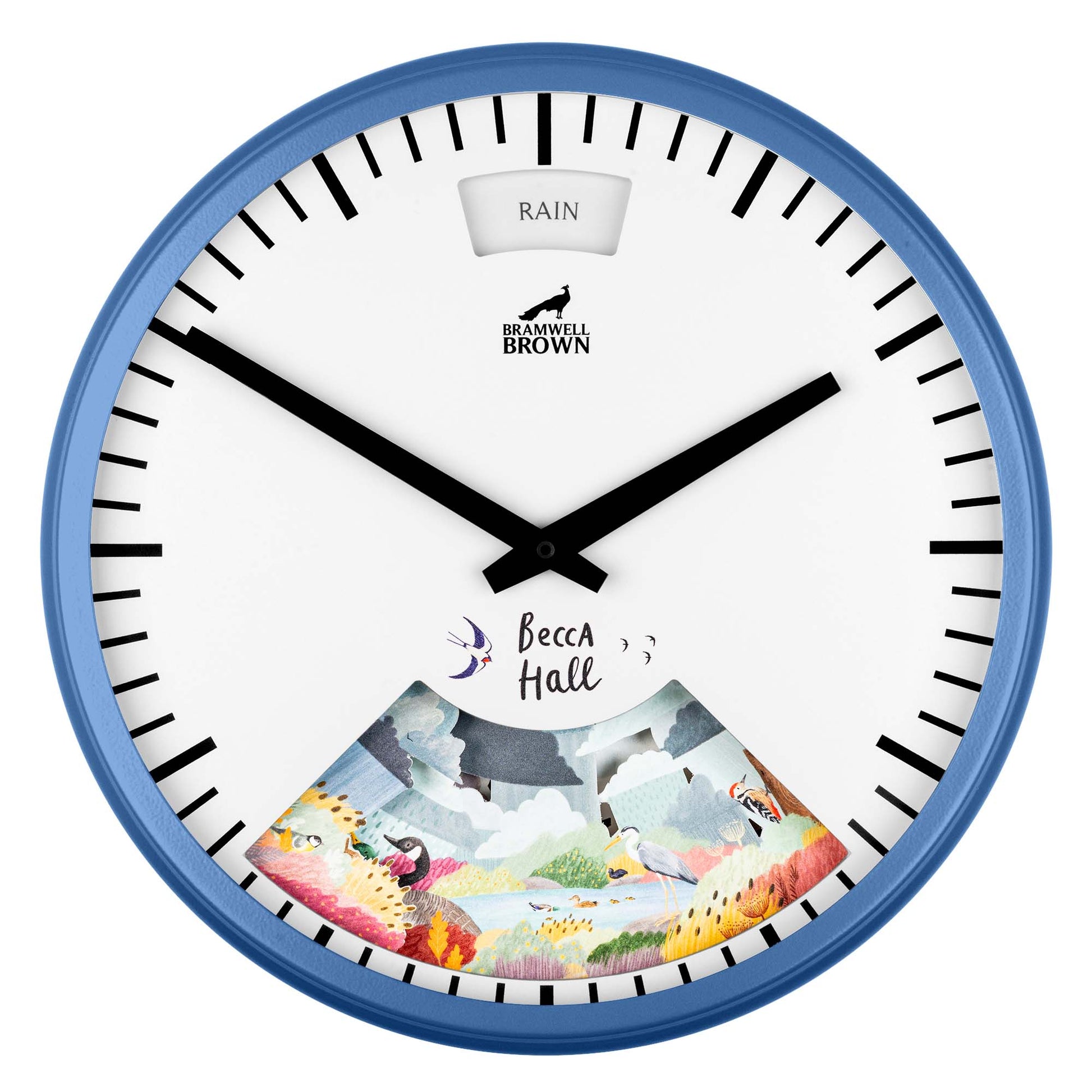 A blue-rimmed wall clock with black hands, Becca Hall written above a colorful illustrated landscape at the bottom and RAIN displayed in a small window at the top. The brand Bramwell Brown is below the window.