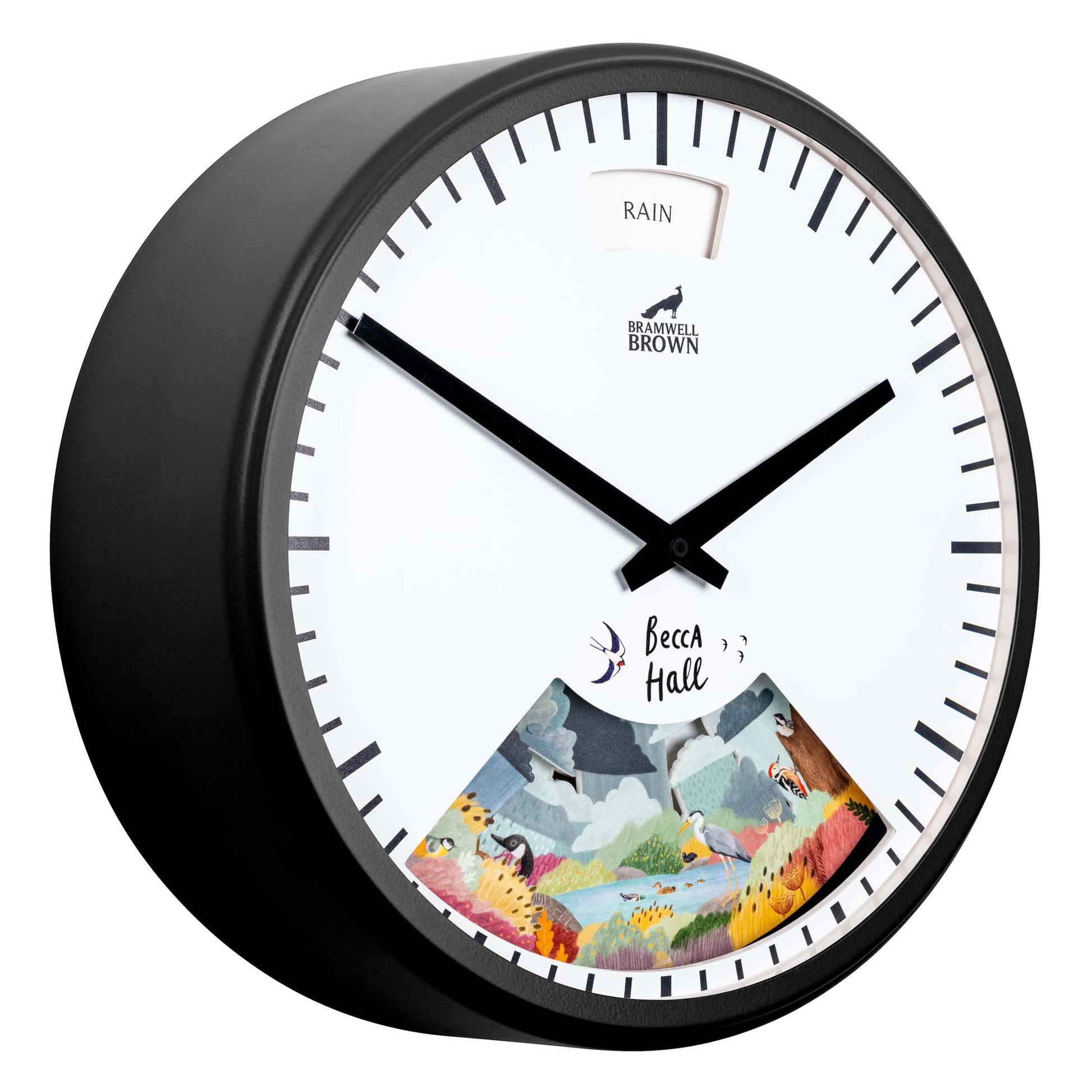 A round wall clock with a white face, black frame, and black hands. The upper part has a RAIN indicator, and the lower part features a colorful illustrated scene with animals and Becca Hall written on it.