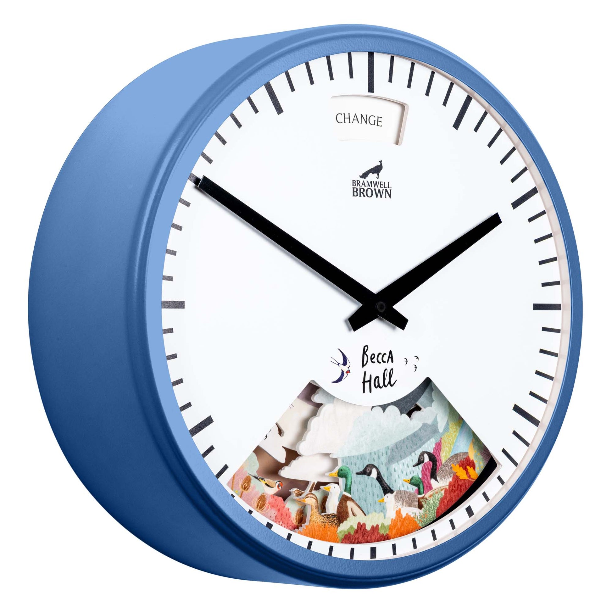 A blue wall clock with black hands and a dial reading CHANGE at the top. The bottom features a colorful illustrated scene of penguins and snowy mountains, with the text Becca Hall above the artwork.