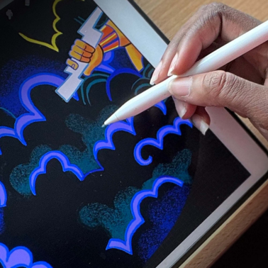 A hand uses a white stylus on a tablet to draw blue, cloud-like shapes. Part of a colorful, cartoon-style character holding a white object is visible on the screen.