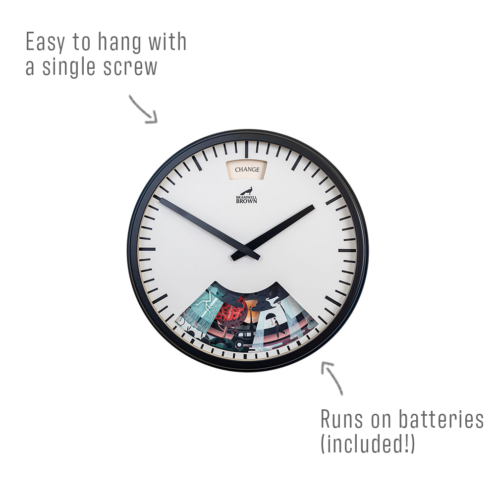 A round wall clock with black frame, labeled Easy to hang with a single screw and Runs on batteries (included!), with a white face, black hands, and colorful graphic details at the bottom.