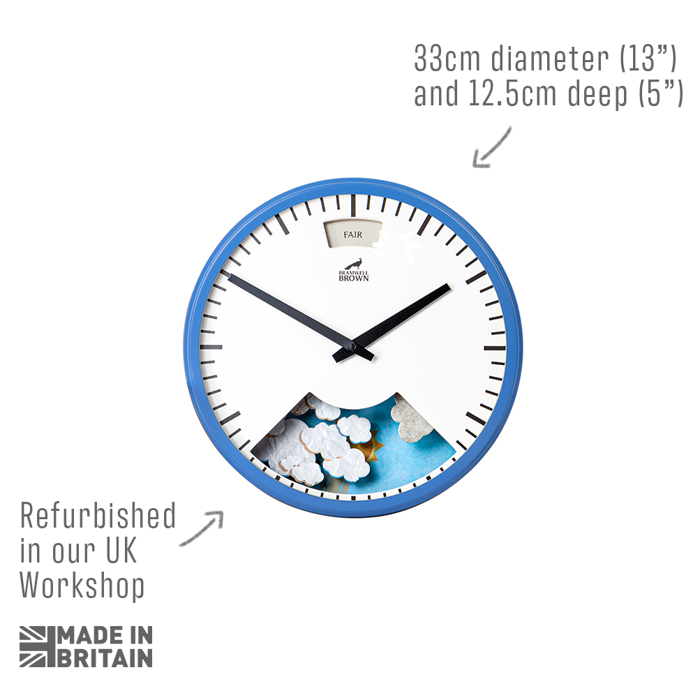 A round wall clock with a blue rim and white face, showing the time as 10:10. Text points to its size (33cm diameter, 12.5cm deep), notes it’s refurbished in the UK, and includes a “Made in Britain” logo.