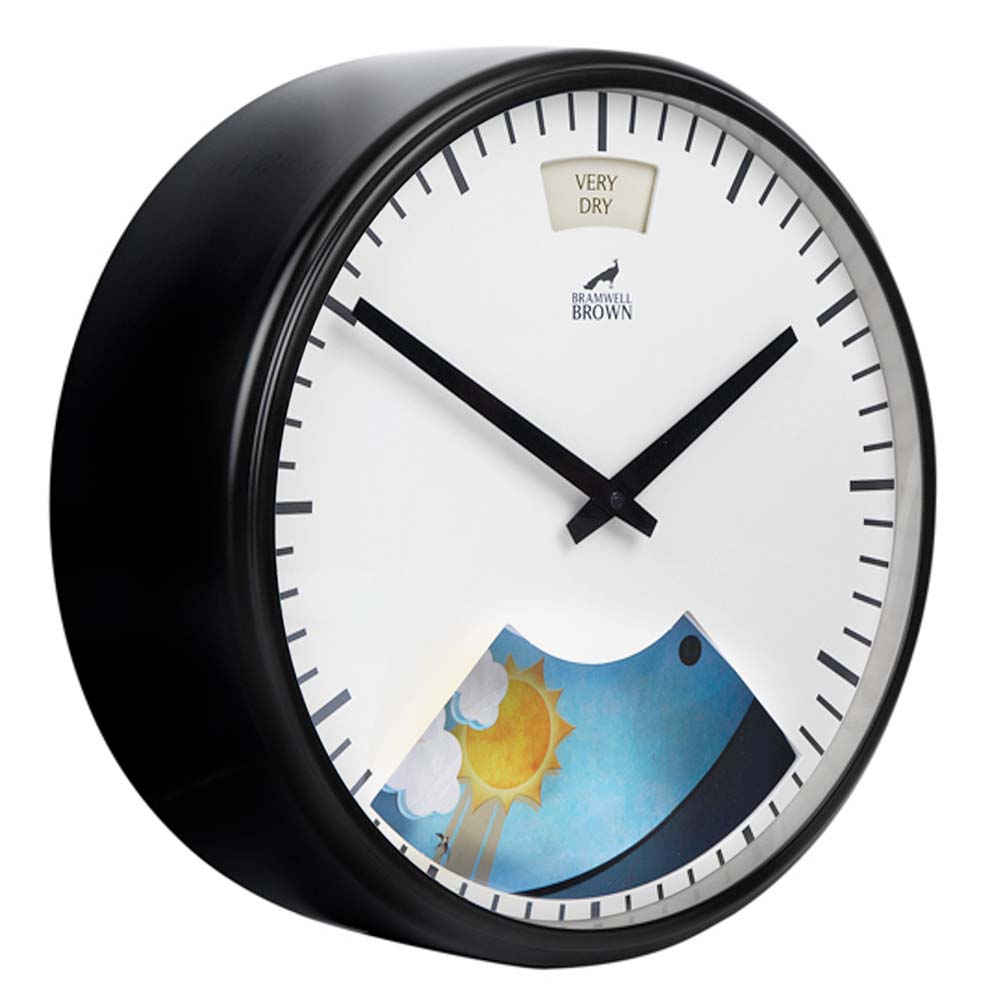 A round wall clock with black frame and hands, showing 10:10. The clock face features a weather-themed illustration of sun and clouds and a humidity indicator labeled VERY DRY at the top.