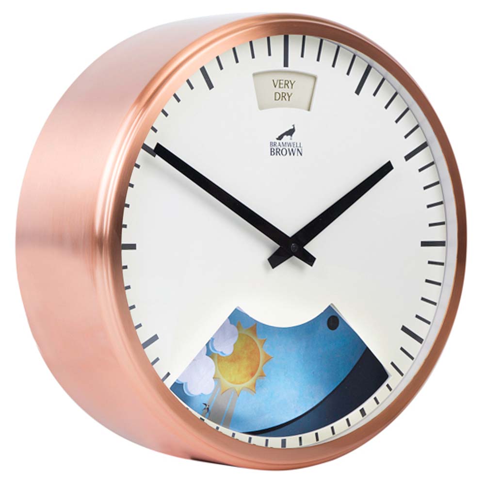 A round wall clock with a copper frame, black hands, and bar hour markers. The top has a VERY DRY weather indicator. The lower section displays a colorful weather scene with sun, clouds, and blue sky.