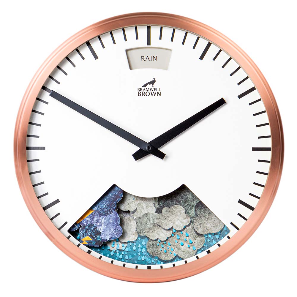 Round wall clock with a copper frame, black hands, and a white face displaying the word RAIN at the top. An animated weather scene with clouds and raindrops is visible in a cutout at the bottom.